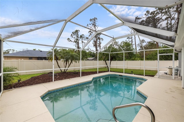 view of swimming pool with a patio area, a fenced in pool, glass enclosure, and a fenced backyard