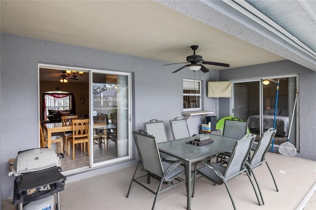 view of patio featuring outdoor dining space, area for grilling, and a ceiling fan