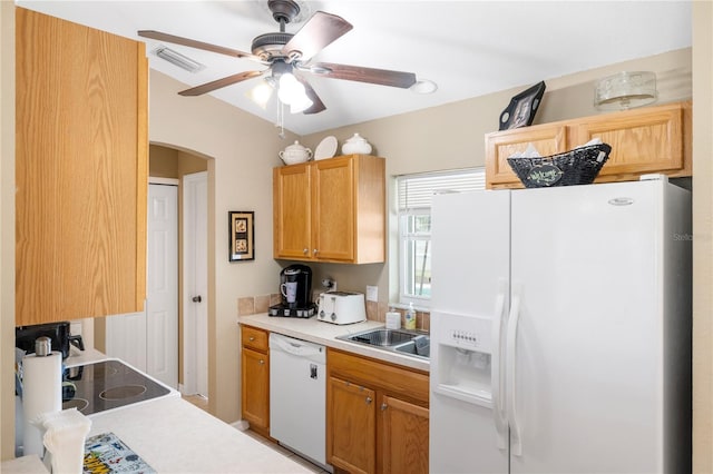 kitchen featuring visible vents, white appliances, light countertops, and a sink