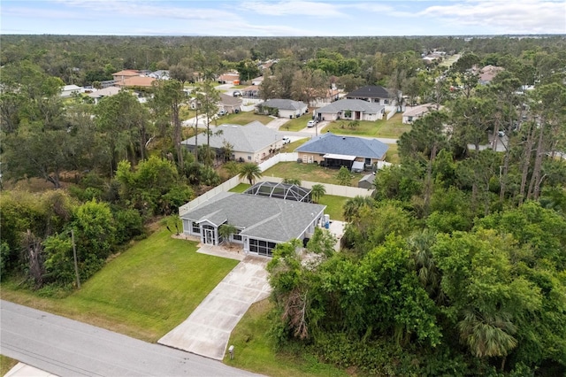 bird's eye view featuring a forest view and a residential view