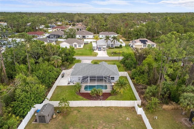 birds eye view of property with a residential view and a view of trees