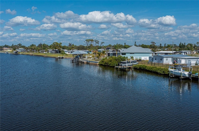 view of water feature featuring a dock and fence