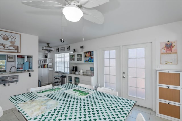 bedroom featuring french doors, light tile patterned flooring, and ceiling fan