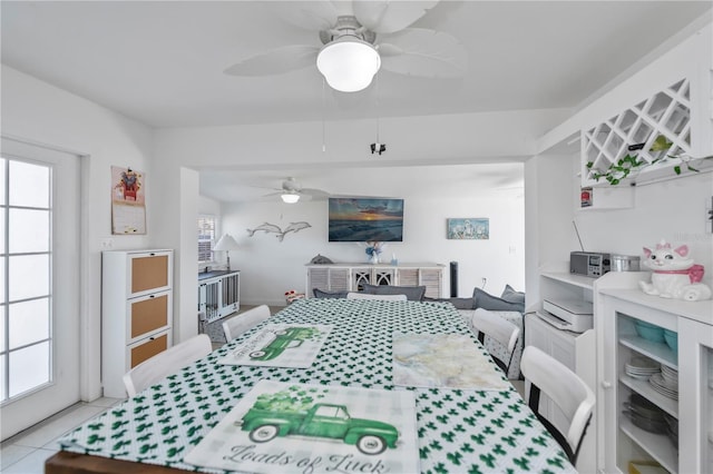 dining room with a ceiling fan and light tile patterned flooring