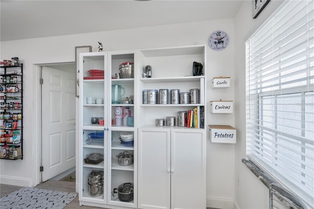 interior space featuring baseboards and wood finished floors