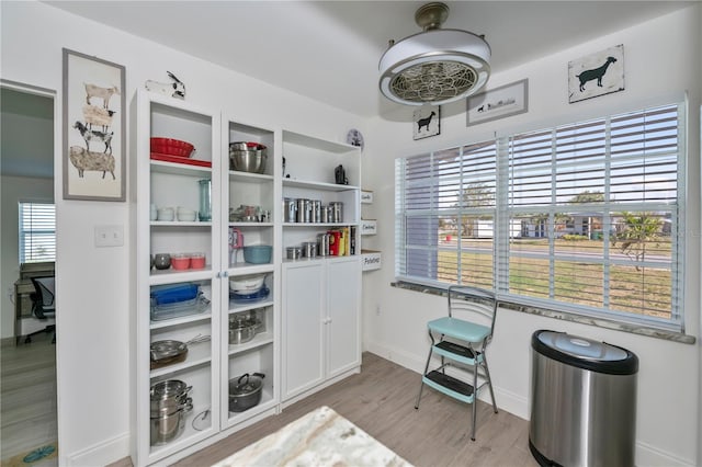 interior space with baseboards and wood finished floors