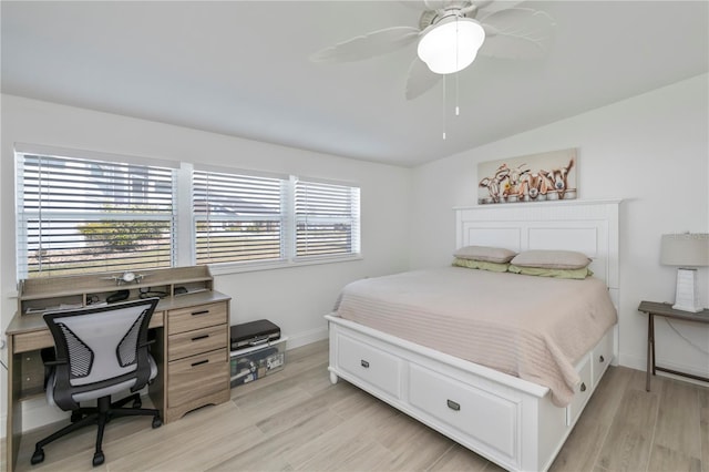 bedroom with light wood-style floors, ceiling fan, baseboards, and vaulted ceiling