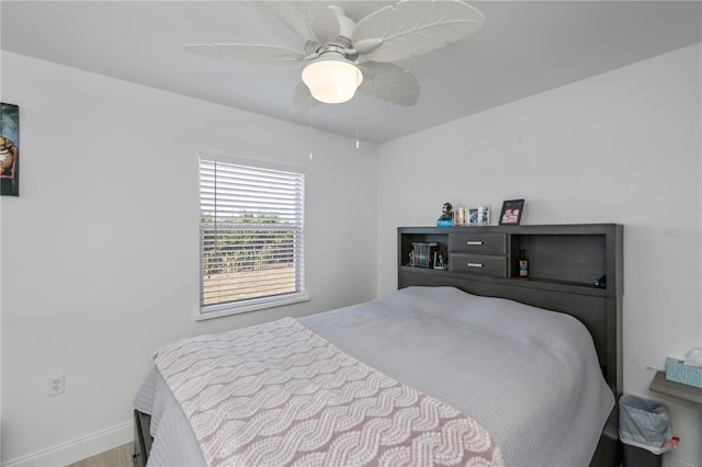 bedroom featuring ceiling fan and baseboards