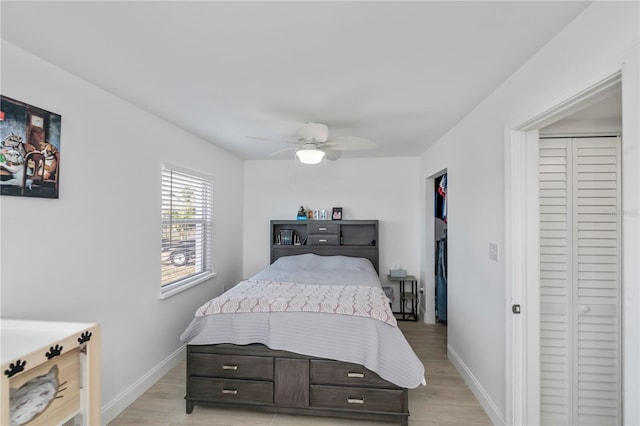 bedroom with light wood-type flooring, ceiling fan, and baseboards