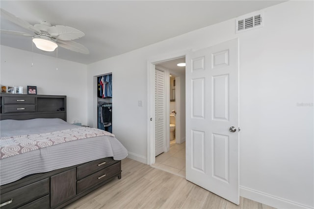 bedroom with a ceiling fan, baseboards, visible vents, light wood-style floors, and a closet