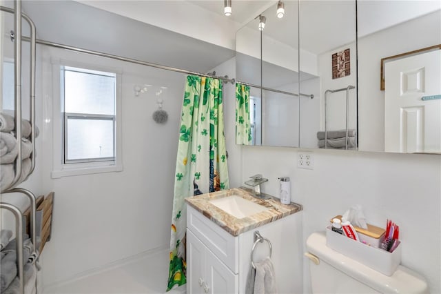 bathroom with a shower with shower curtain, vanity, and toilet