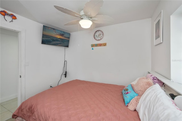 tiled bedroom featuring ceiling fan