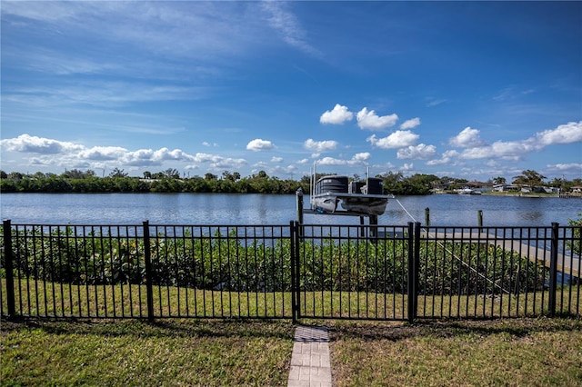 water view featuring fence, boat lift, and a boat dock