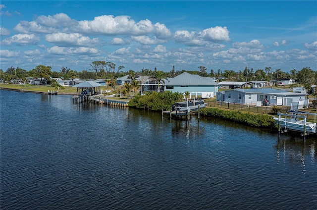 view of water feature featuring fence and a boat dock