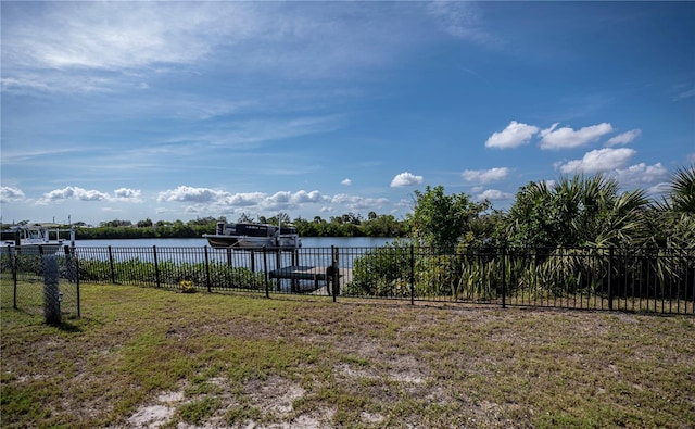 view of yard with a water view and fence