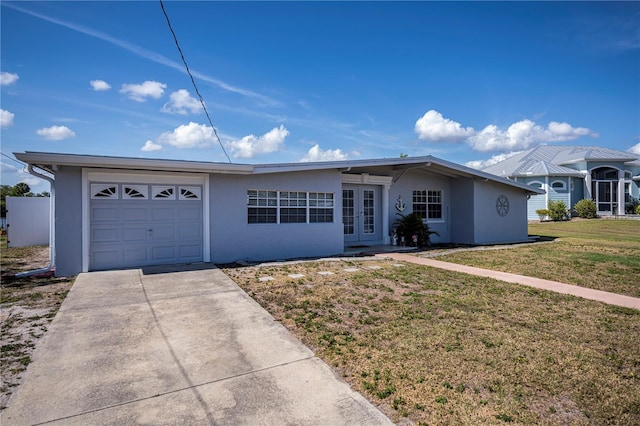 ranch-style house featuring french doors, stucco siding, an attached garage, a front yard, and driveway