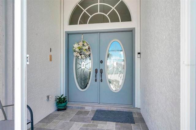 property entrance with stucco siding