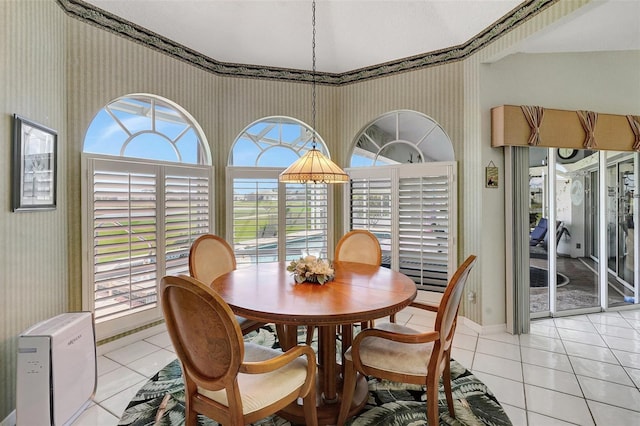 dining room with wallpapered walls and light tile patterned floors