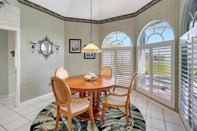 dining area featuring light tile patterned floors and baseboards