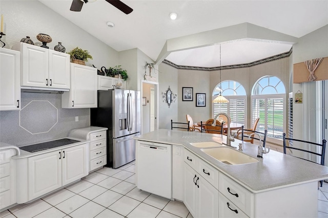 kitchen with black electric stovetop, white cabinets, stainless steel fridge with ice dispenser, dishwasher, and an island with sink