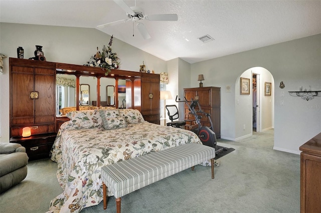 bedroom featuring arched walkways, lofted ceiling, visible vents, light carpet, and baseboards