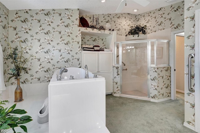 bathroom with a ceiling fan, a shower stall, a bath, and wallpapered walls