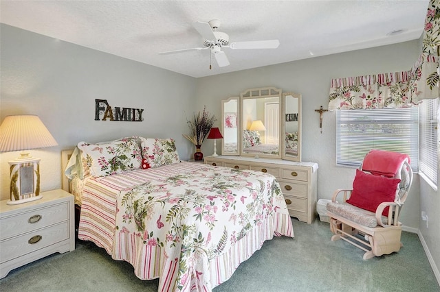 bedroom with a ceiling fan, carpet flooring, and a textured ceiling