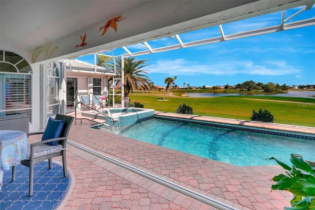 view of pool with a lawn, a patio, glass enclosure, a water view, and a pool with connected hot tub