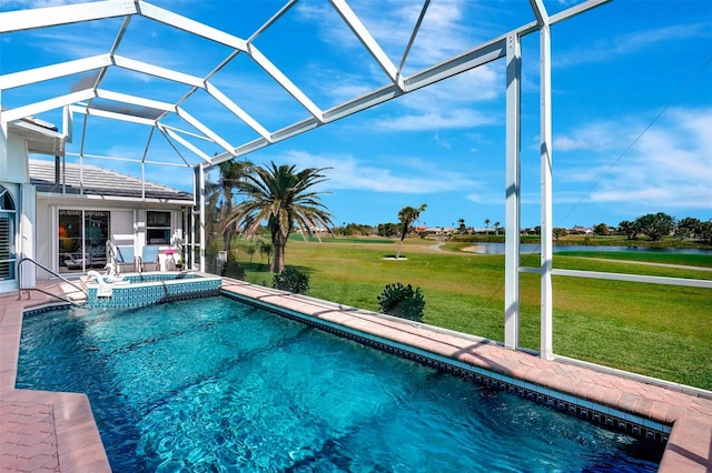 view of pool with glass enclosure, a water view, a pool with connected hot tub, a yard, and a patio area