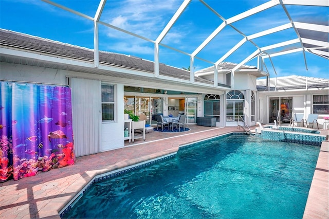 outdoor pool with a lanai, a patio, and an in ground hot tub