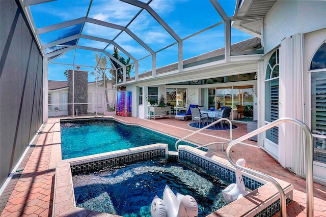 view of swimming pool with a lanai, a patio area, a fenced in pool, and an in ground hot tub