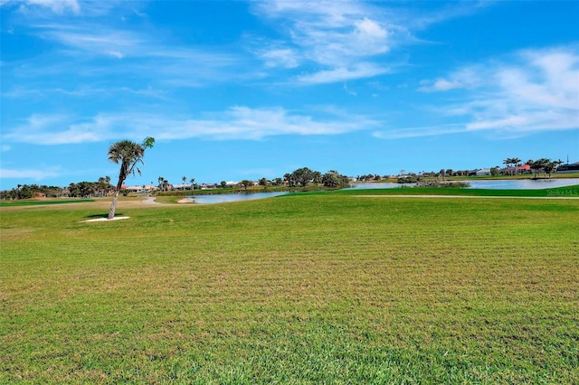 view of property's community with a yard and a water view