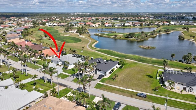 birds eye view of property featuring a residential view, view of golf course, and a water view