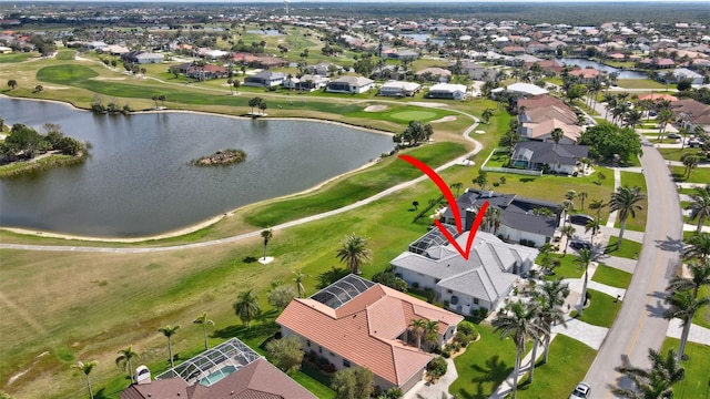 aerial view featuring a water view, view of golf course, and a residential view