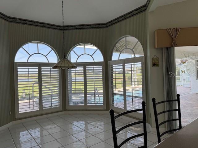 507 Monaco Dr, Punta Gorda, FL 33950 - unfurnished dining area with light tile patterned floors and wallpapered walls