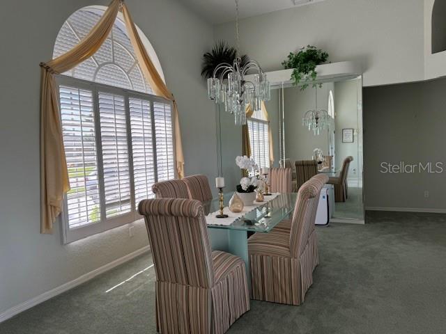 507 Monaco Dr, Punta Gorda, FL 33950 - dining room with a chandelier, carpet, and baseboards