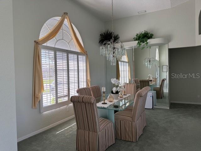 507 Monaco Dr, Punta Gorda, FL 33950 - dining room with carpet flooring, a chandelier, and baseboards