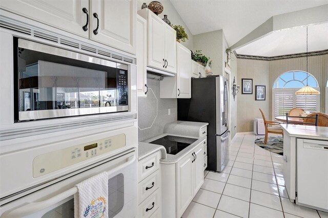 507 Monaco Dr, Punta Gorda, FL 33950 - kitchen featuring appliances with stainless steel finishes, light countertops, white cabinets, light tile patterned flooring, and baseboards