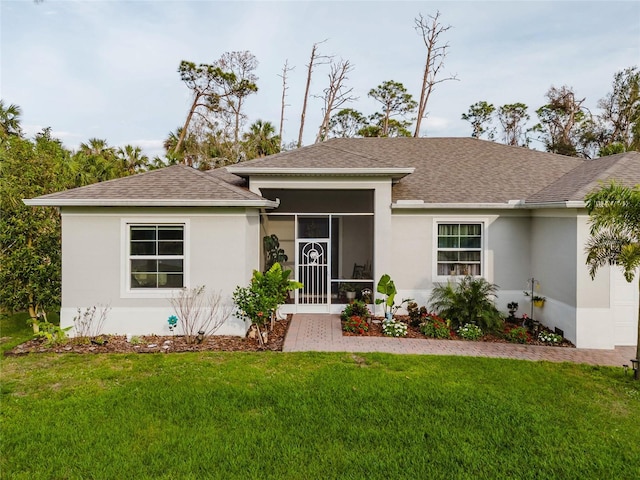 ranch-style house with stucco siding, roof with shingles, and a front yard