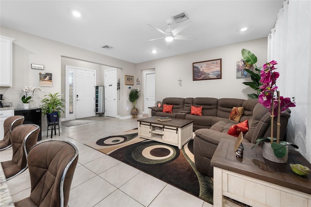 living room featuring light tile patterned floors, ceiling fan, visible vents, and recessed lighting