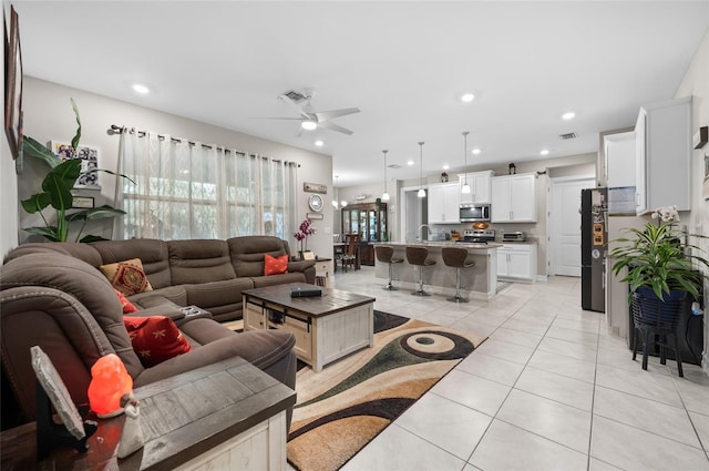 living room with ceiling fan, light tile patterned flooring, visible vents, and recessed lighting