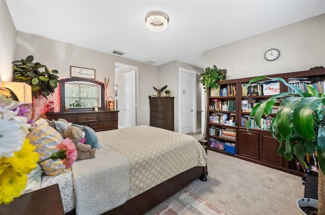 bedroom with light carpet and visible vents