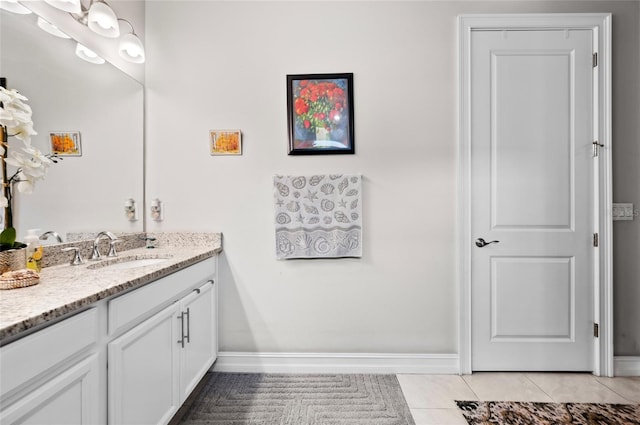 bathroom featuring tile patterned flooring, baseboards, and vanity