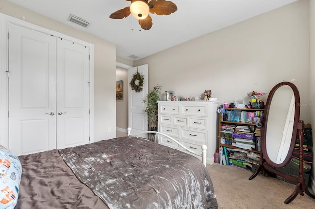 bedroom with a closet, carpet, visible vents, and a ceiling fan