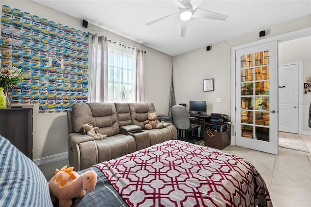 bedroom featuring light tile patterned floors, a ceiling fan, and baseboards