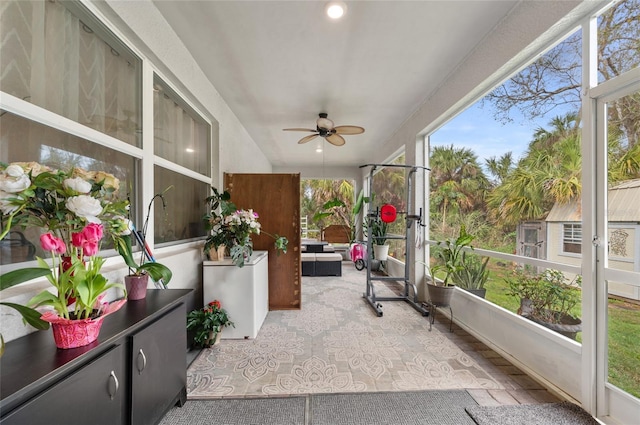 sunroom / solarium with a ceiling fan