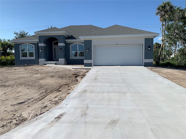 209 Annapolis Ln, Rotonda West, FL 33947 - view of front of property with a garage, roof with shingles, stucco siding, and driveway