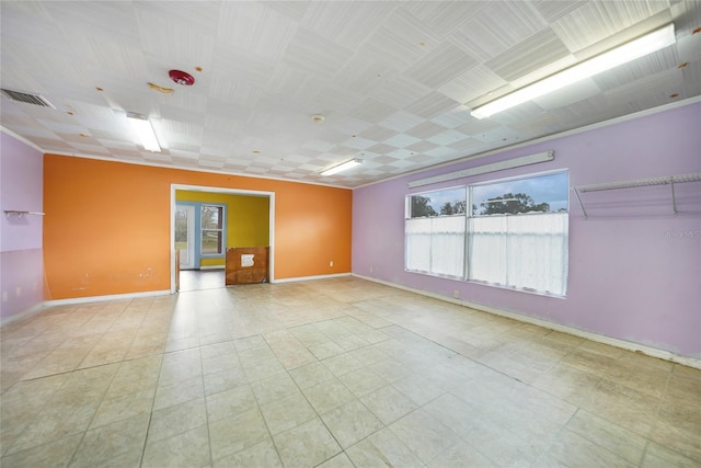 empty room featuring visible vents and baseboards