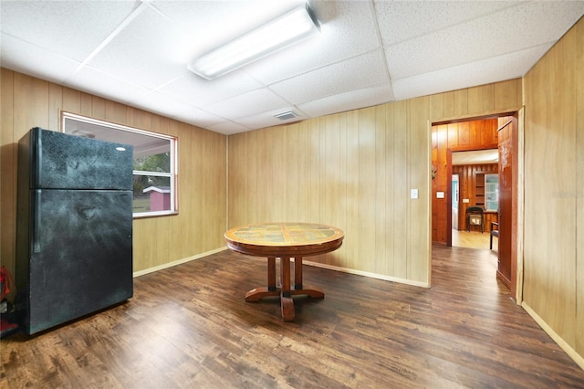 dining room with a paneled ceiling, visible vents, baseboards, and wood finished floors