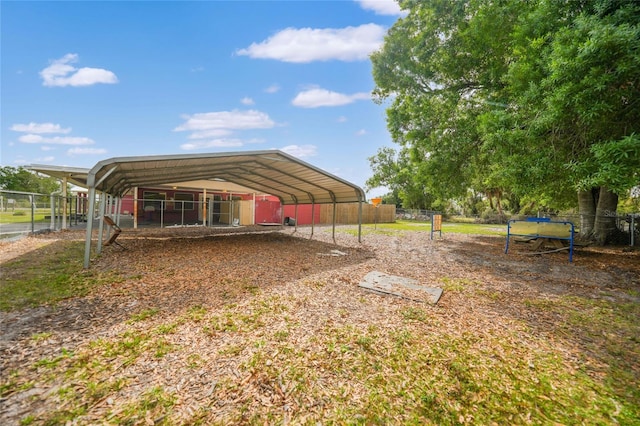 exterior space featuring a carport and fence